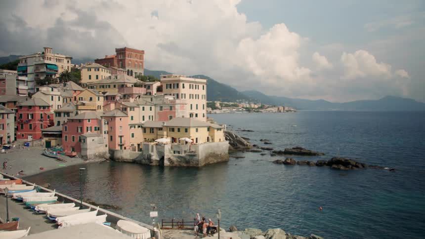 Old world buildings sit at water's edge in a coastal community