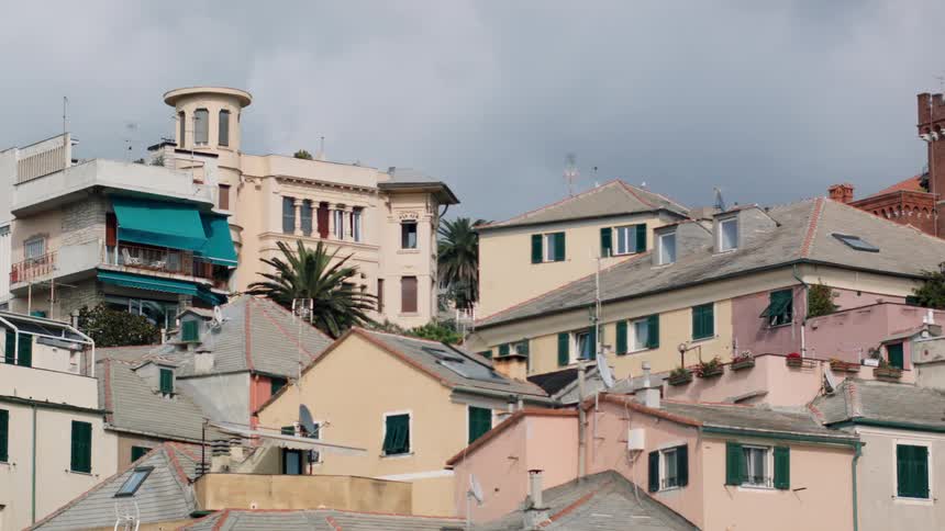 Clouds float over a cluster of homes and buildings