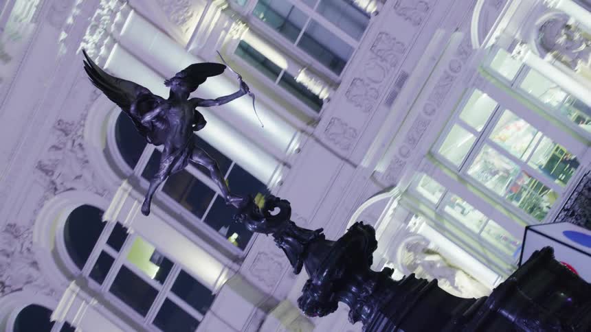 Artistic representation of a bronze monument in a city square at night
