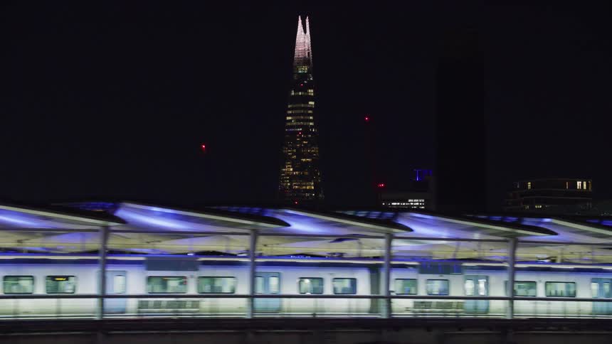 The shard building against night sky train platform below