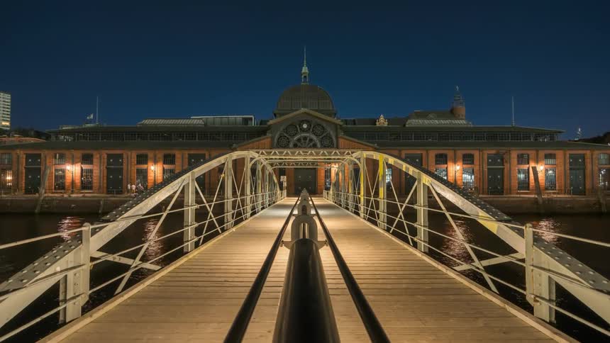 A bridge over the water towards a building