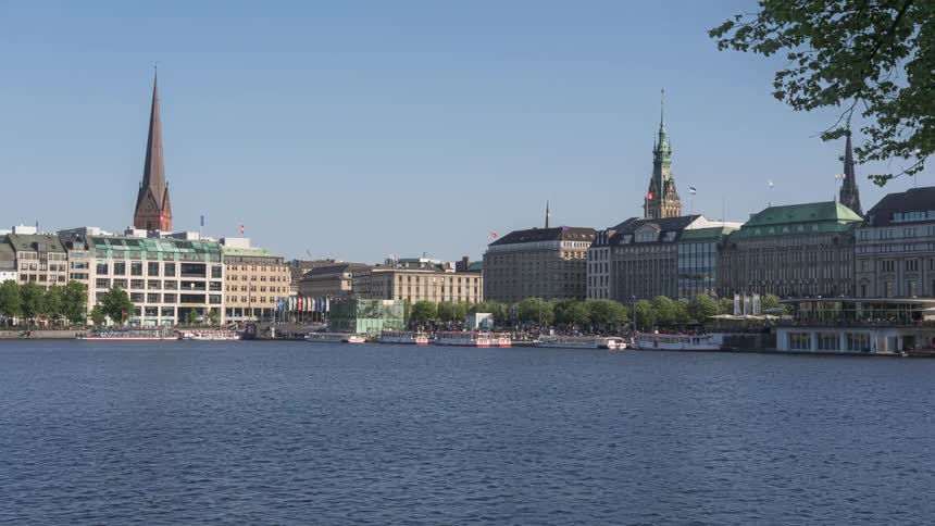 View of a city by the sea with thousands of people walking