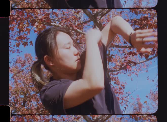 A person doing karate moves outdoors on a fall day