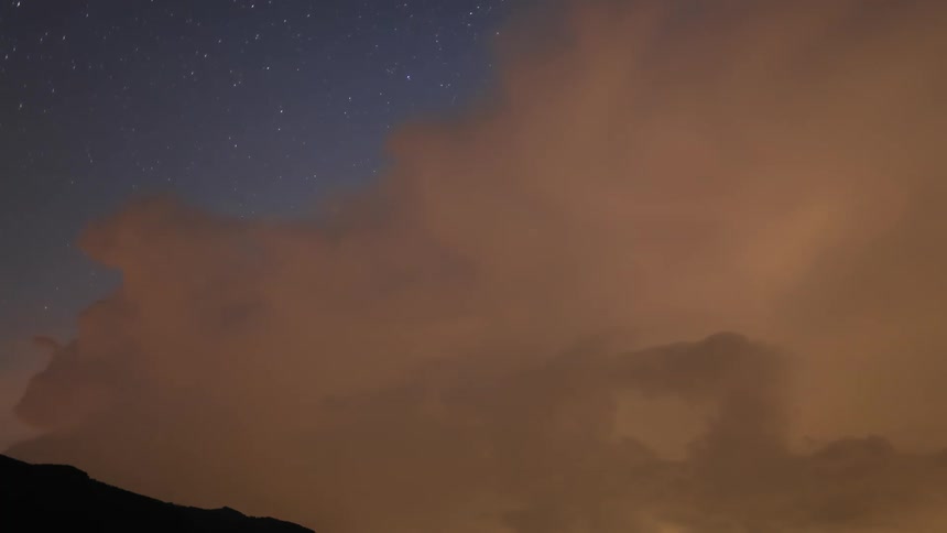 Comet Neowise and stars during flashing thunderstorm at night