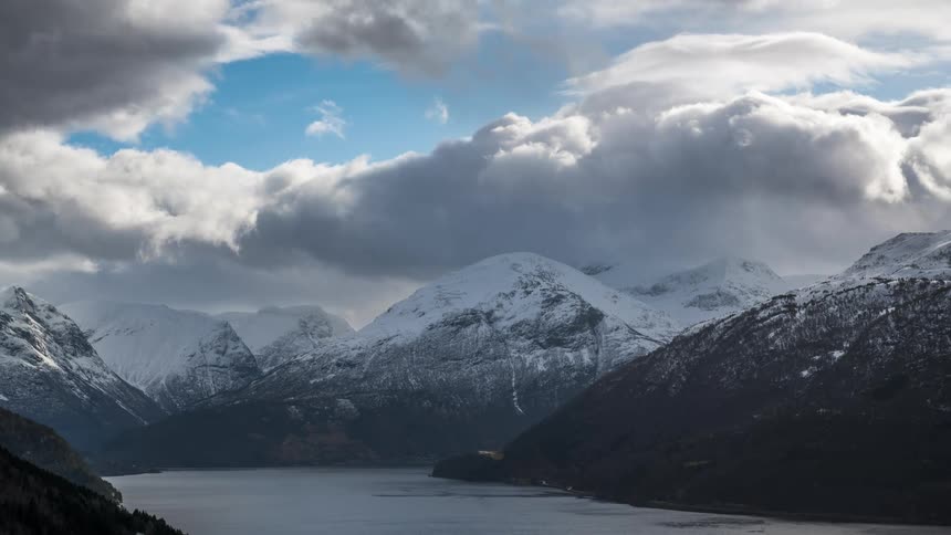 A fjord in the midst of mountains covered in snow