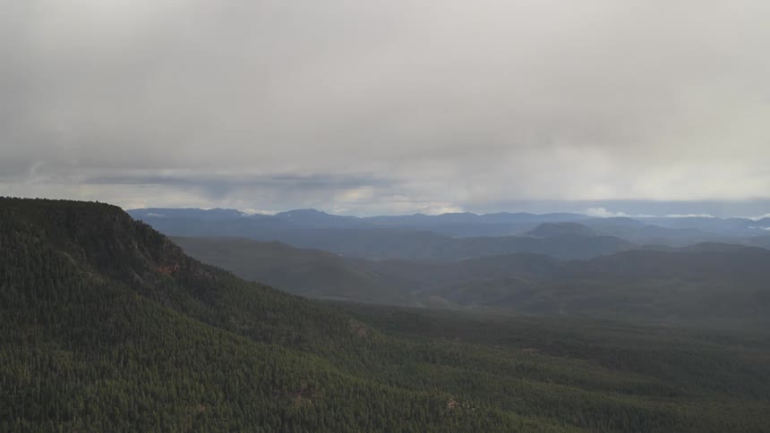 A mountainous terrain under a dark overcast sky