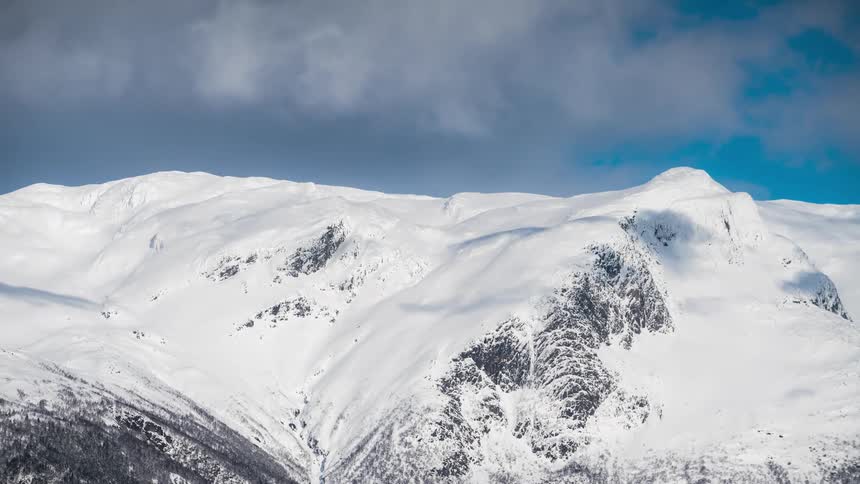Aerial of a snowy mountain range on sunny days