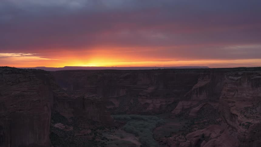 Panoramic timelapse landscape of the sun setting over the horizon of the canyons