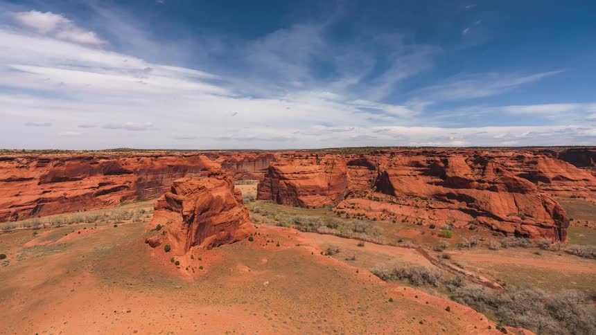 Clouds passing over desert mountains and canyons