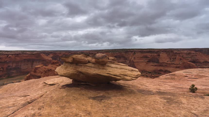 Natural panorama of craters amidst rocky rocks on a cloudy day in timelapse