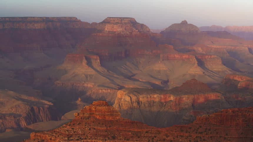 Cloud shadows move across a deep canyon