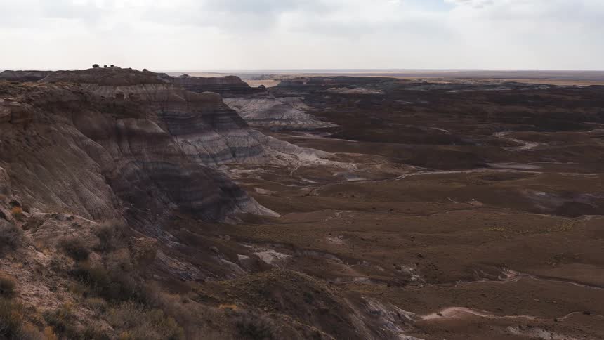 Clouds passing over plateau and valley cover terrain in shadows