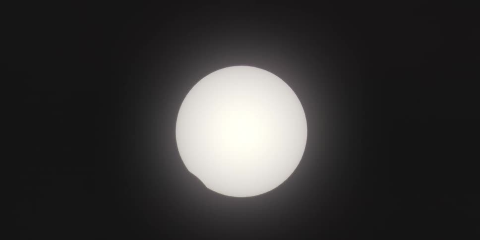 The moon barely covering the sun during a total solar eclipse