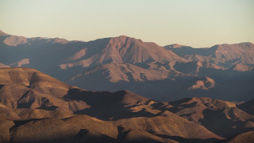 shadows at sunset moving over a desert mountain range