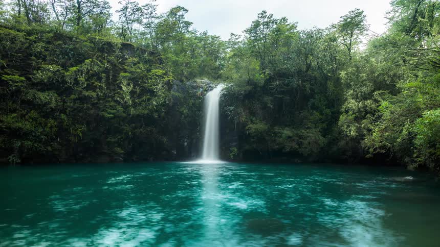 Landscape of a small waterfall with crystal clear waters in timelapse