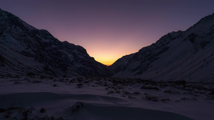 Time lapse sunset snow covered canyon