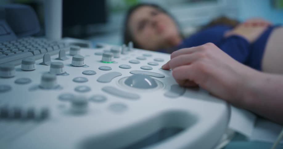A person pressing buttons on a medical machine