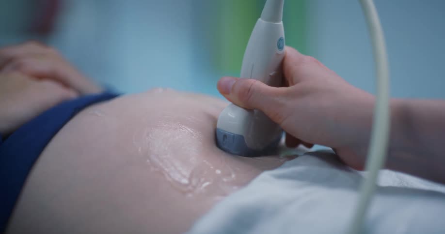 A health professional administers a sonogram to a female patient