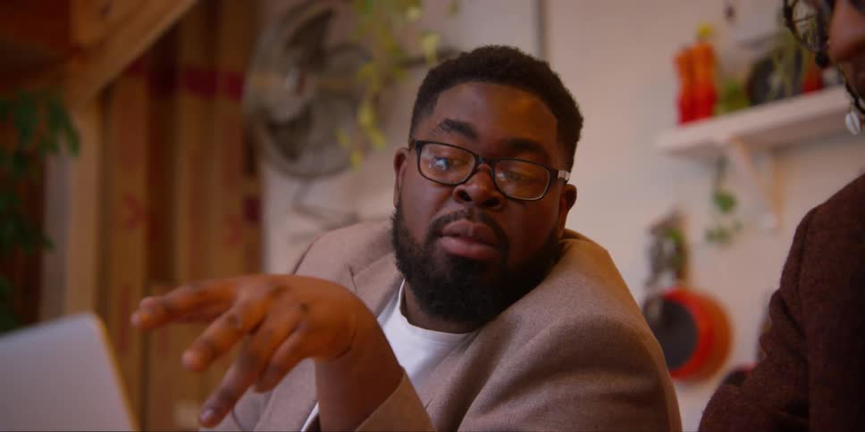 Portrait of a man talking analytically to his colleague next to him