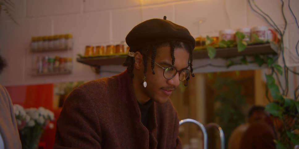 Two black men stare and converse