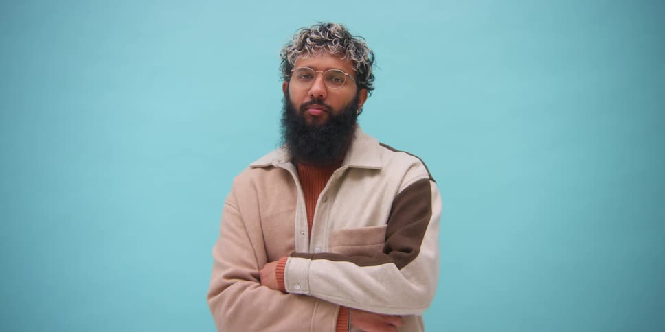 Man modeling in blue background studio