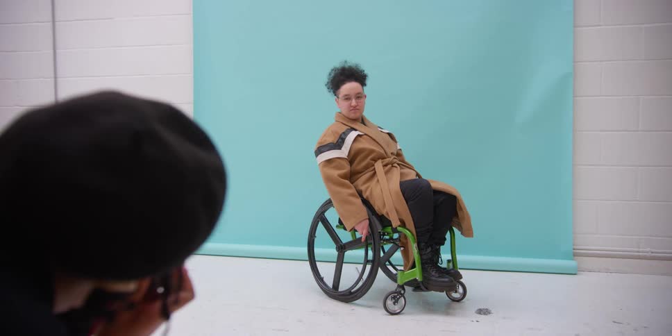 Model being photographed inside a studio