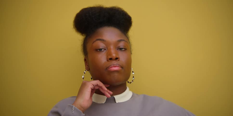 A black woman strikes a pose