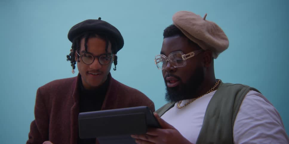 Men analyzing images on a tablet