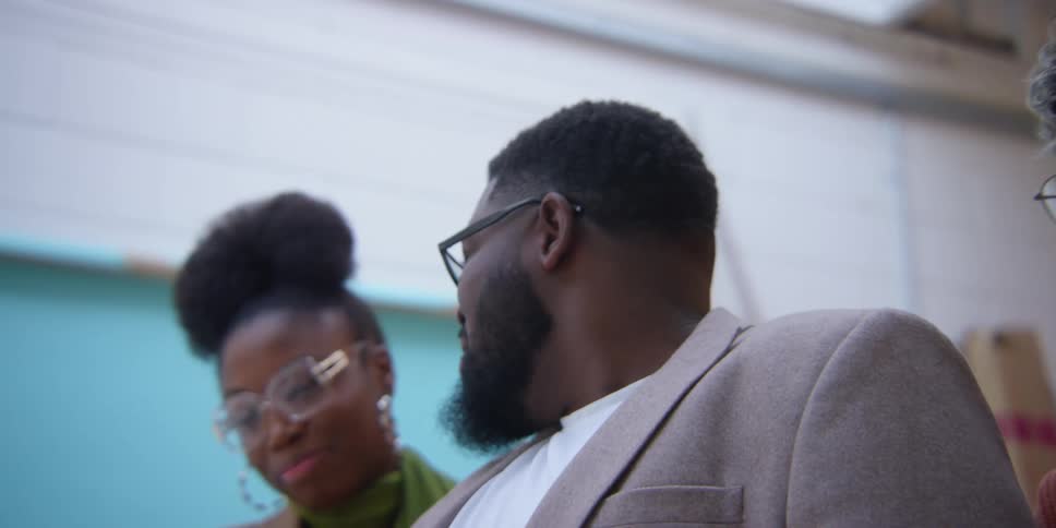 Portrait of a man and a woman looking down talking and smiling