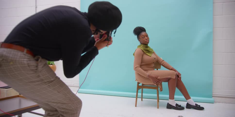 A photo shoot of a young woman in a photo studio