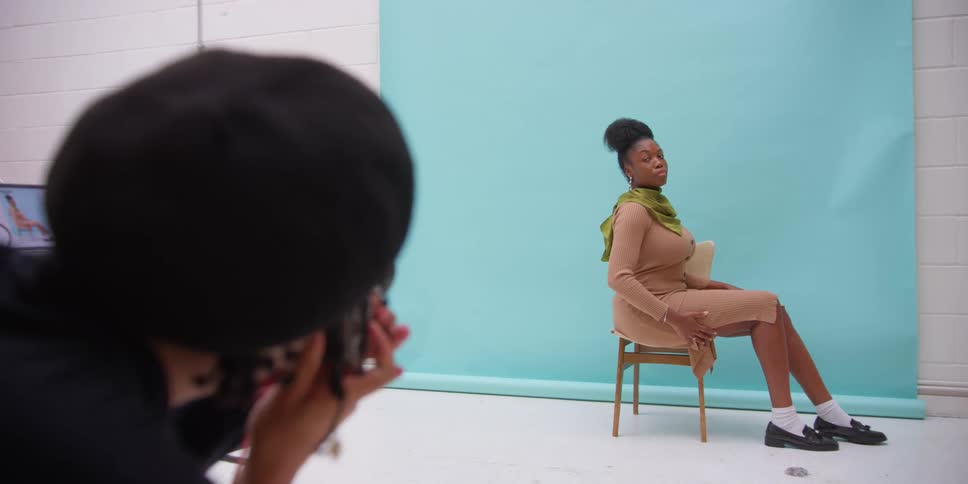 A man is photographing a model