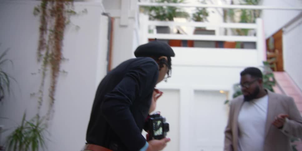 A photographer pointing out things in a studio
