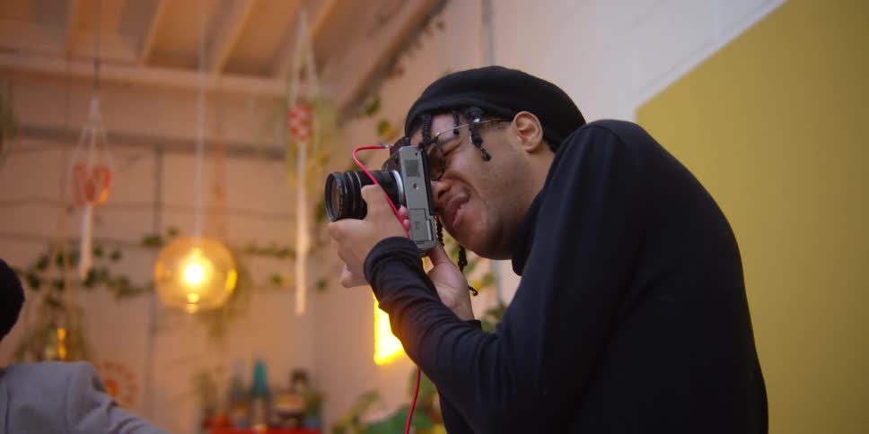 A man is aiming his camera