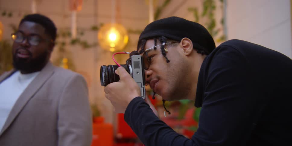 A man focused on photographing something with a camera