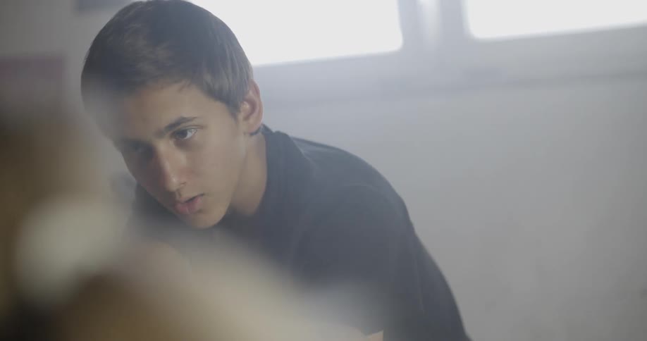 Young boy talking to someone else in a room