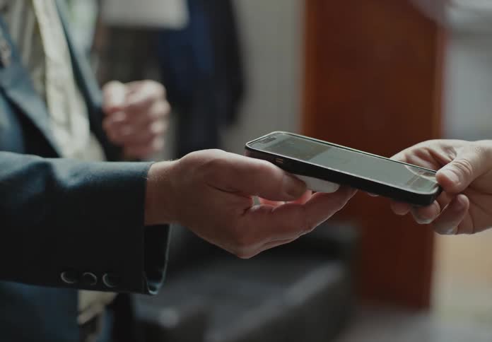 Close up of a person making a payment with a smartphone