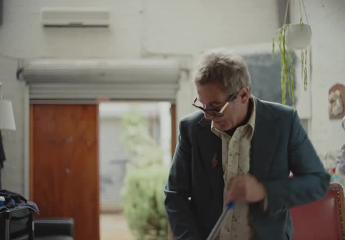 Barber passing a broom inside his establishment