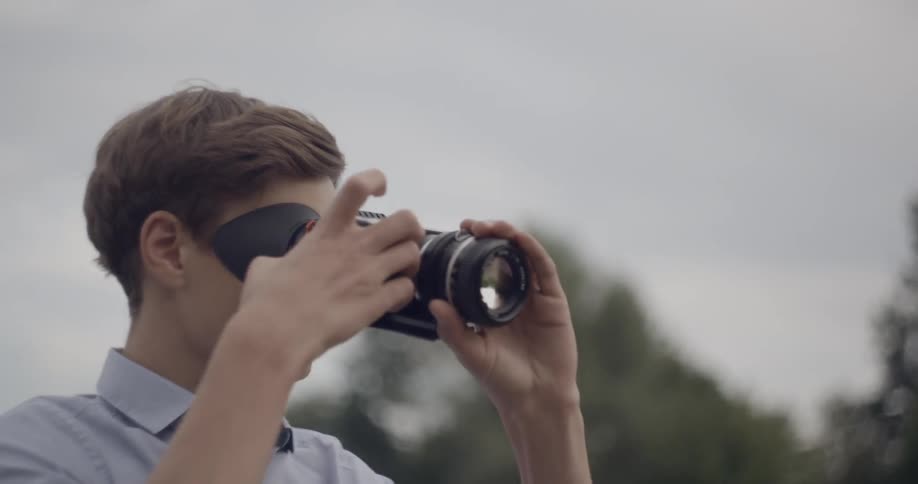 A boy is looking through a scope