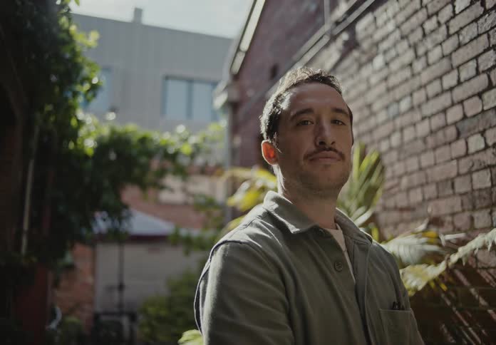 Portrait of a man in a garden outside inside the house