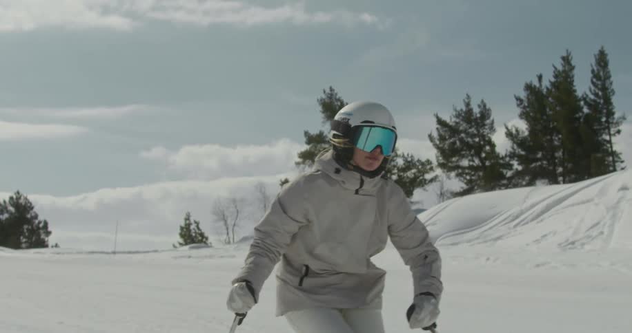 A woman skiing in the snow during the day