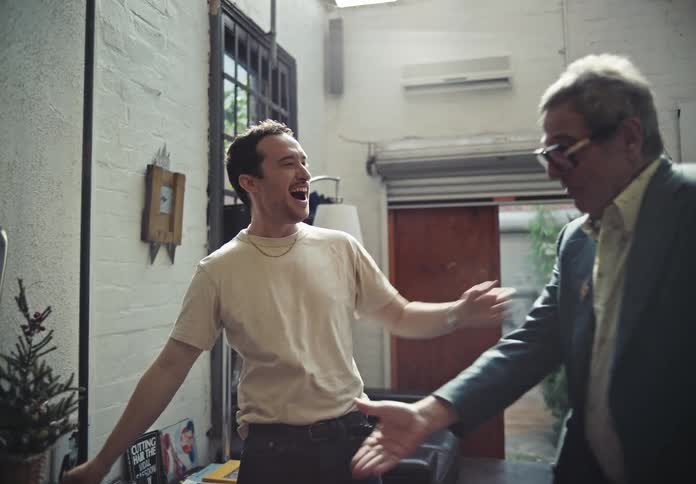 A barber greets a client
