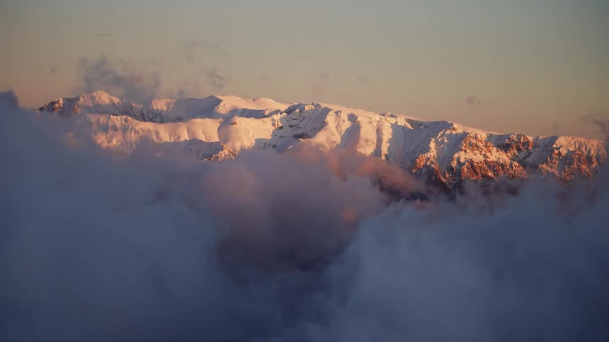 Frame of mountain range covered by snow at cloud level on a morning