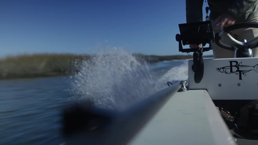 Man piloting a small boat on the river