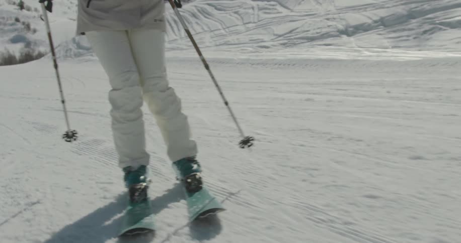 Skier riding down on a snowy slope