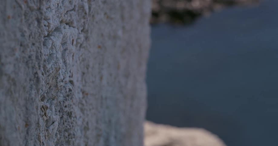 Man with his hands stuck in a mountain wall letting go of his hands