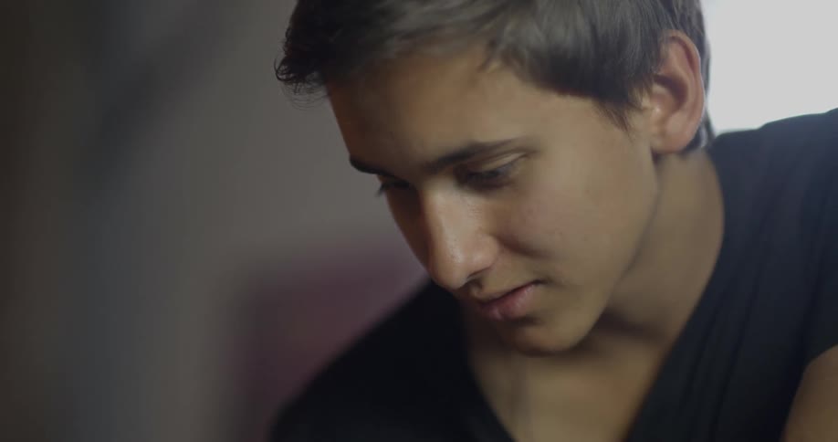 A young man wearing a black shirt converses