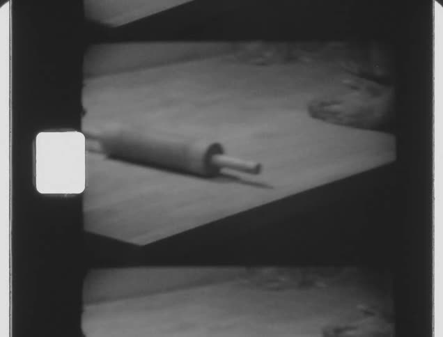 Woman using a rolling pin to prepare homemade dough