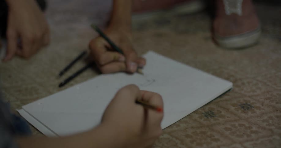 People draw with pencils on paper