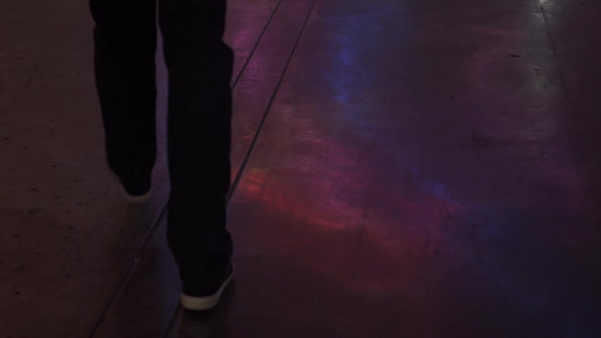 A man walks down a city sidewalk