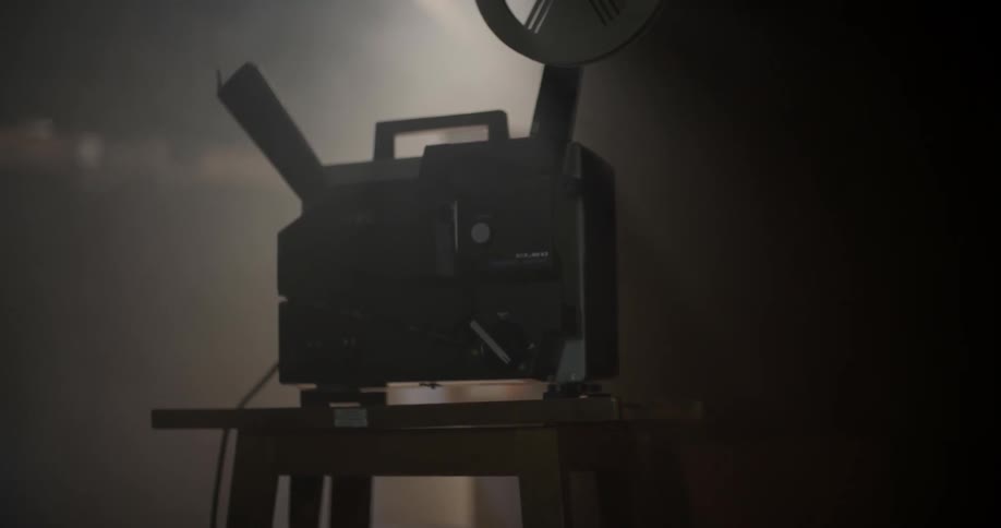An old film projector sits on a stand
